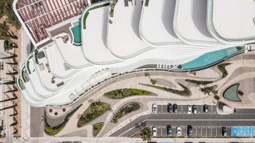 two rippling volumes unite luxury commercial and residential spaces along limassol seafront, cyprus