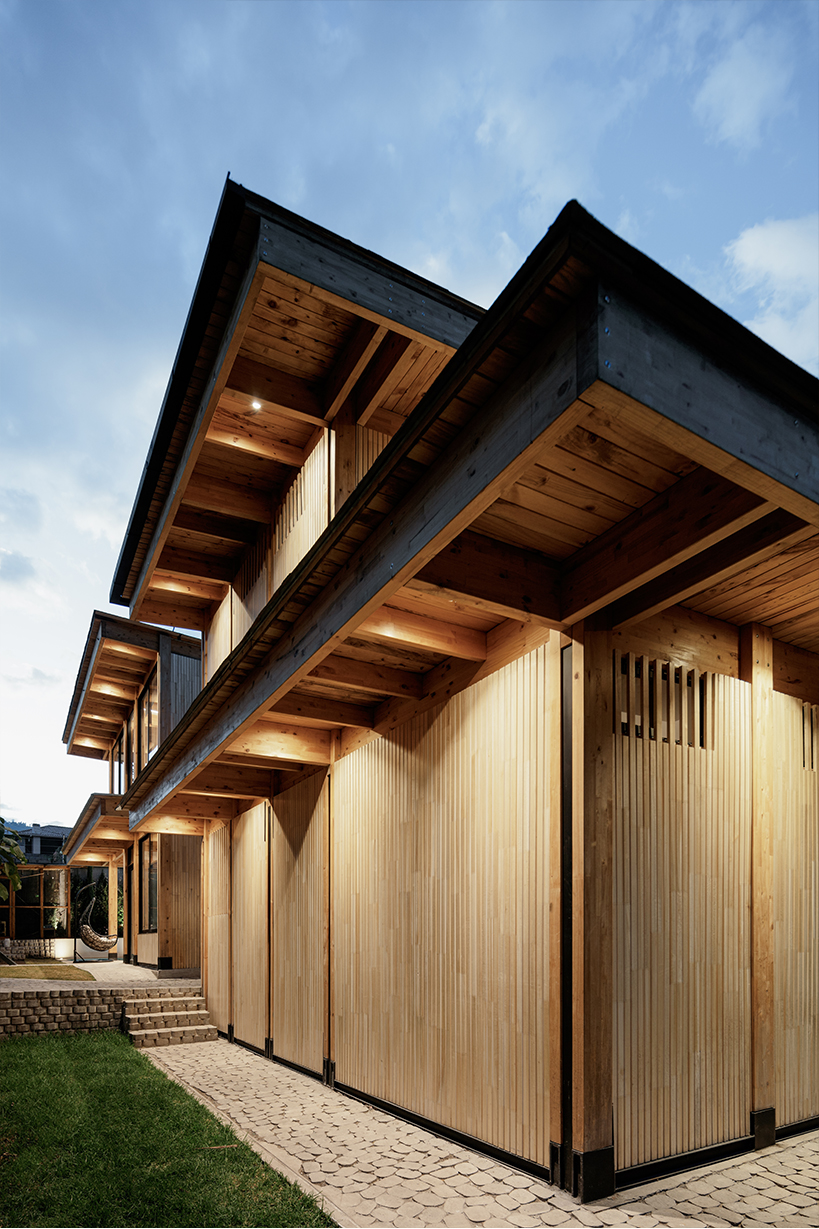 two identical wooden blocks form a mirroring c-shape residence in ecuador - 3