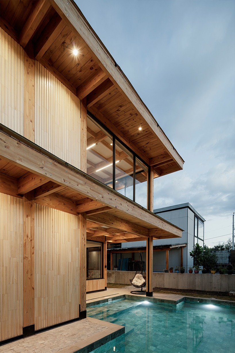 two identical wooden blocks form a mirroring c-shape residence in ecuador - 4