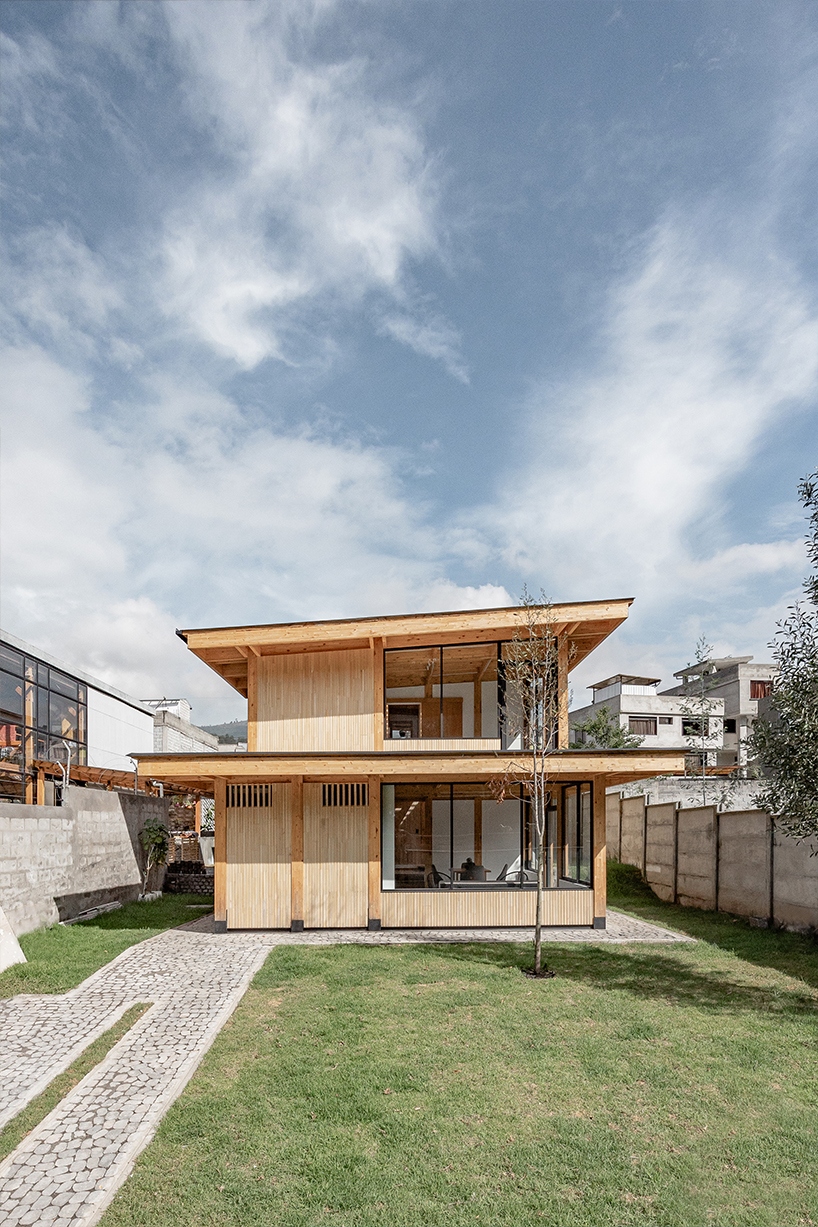 two identical wooden blocks form a mirroring c-shape residence in ecuador - 2