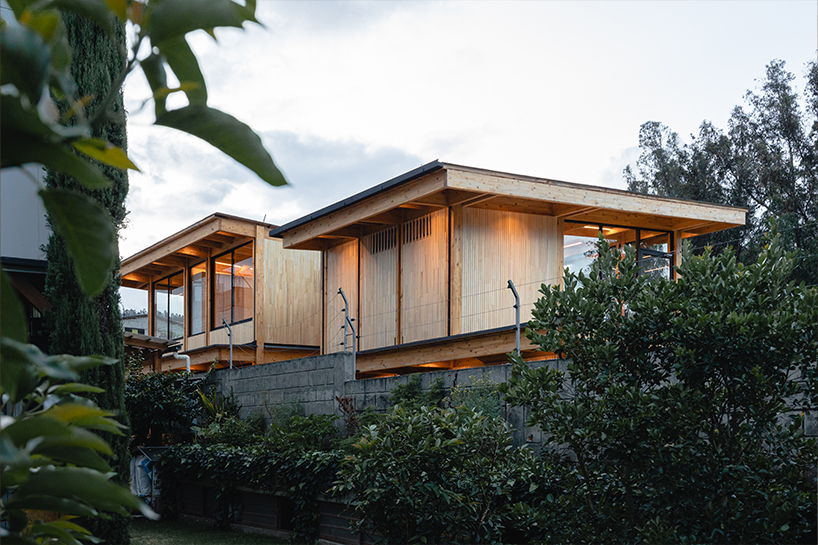 two identical wooden blocks form a mirroring c-shape residence in ecuador - 1