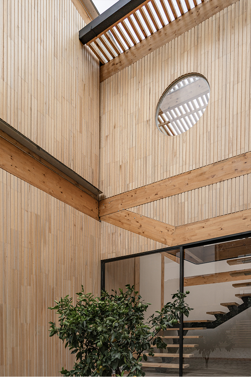 two identical wooden blocks form a mirroring c-shape residence in ecuador - 7