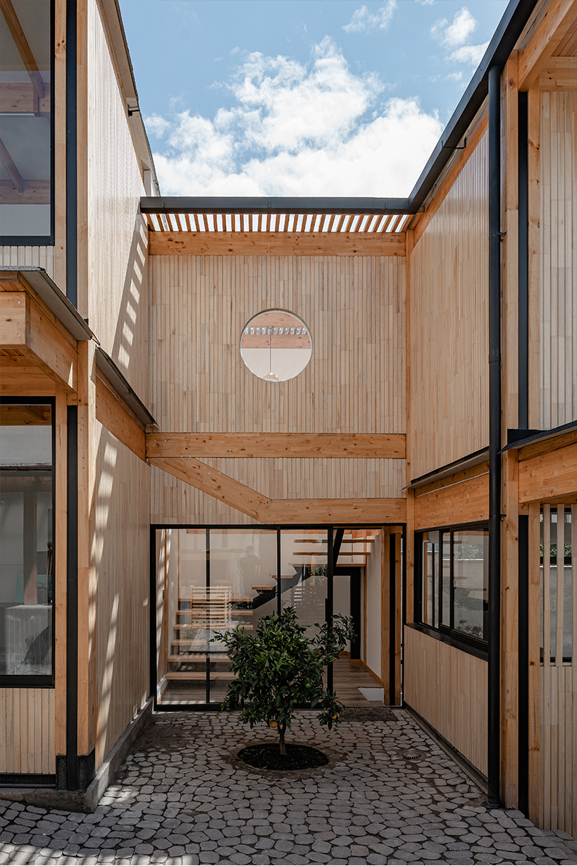 two identical wooden blocks form a mirroring c-shape residence in ecuador - 6
