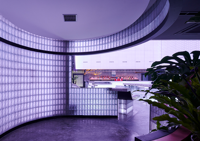 neon lights permeate glass block walls of renovated hidden basement bar in indonesia - 4