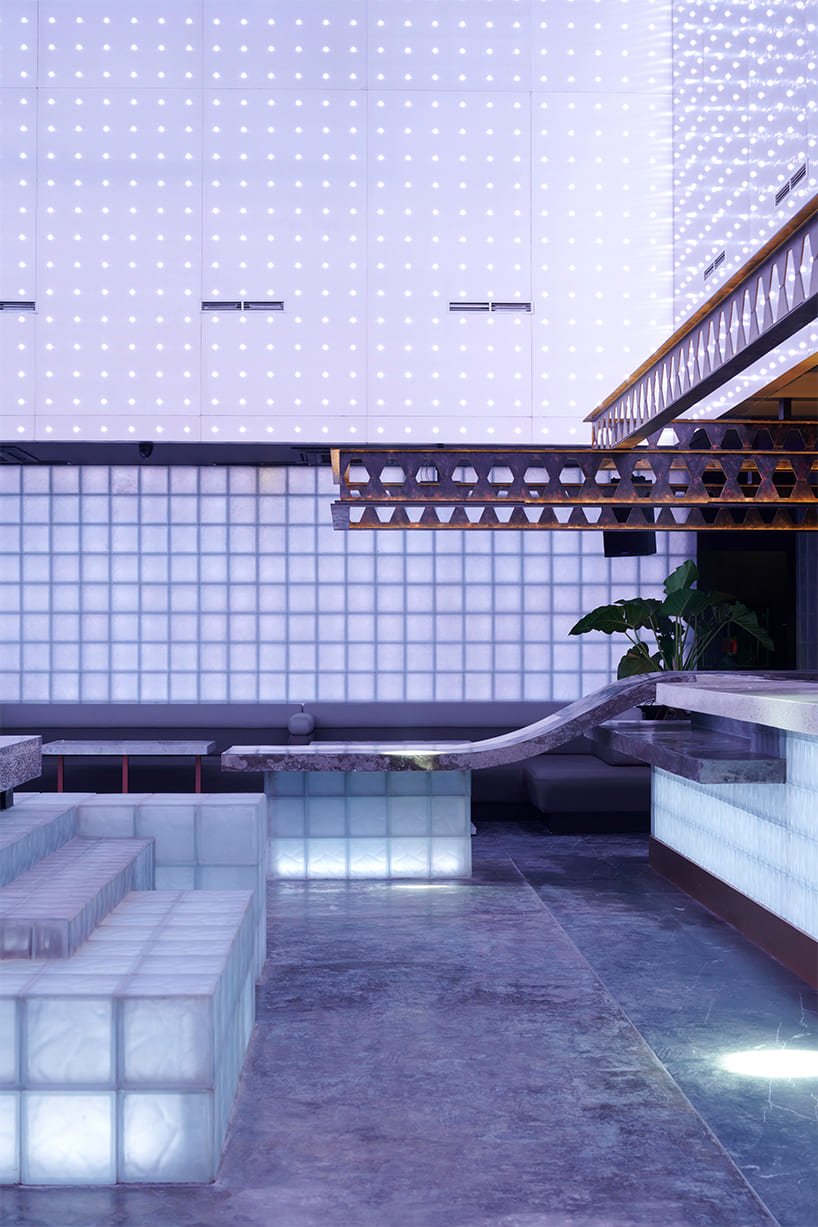 neon lights permeate glass block walls of renovated hidden basement bar in indonesia - 5