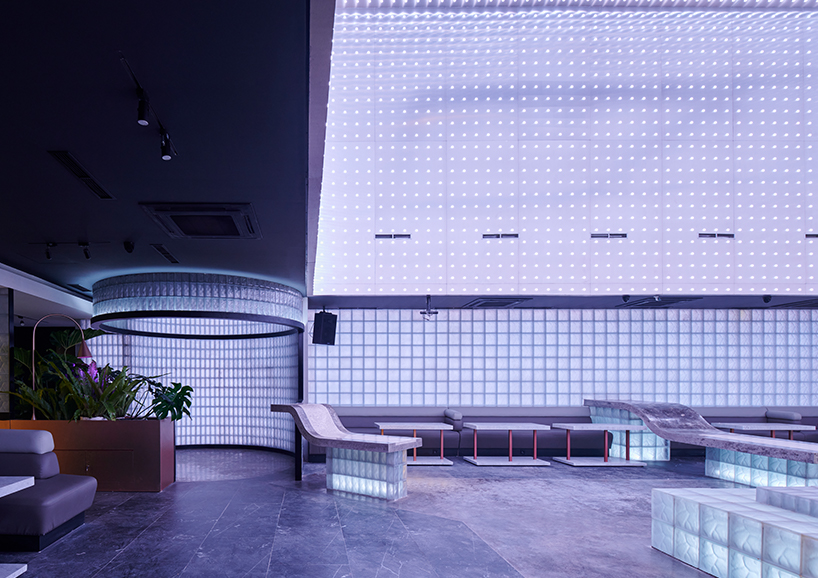 neon lights permeate glass block walls of renovated hidden basement bar in indonesia - 1