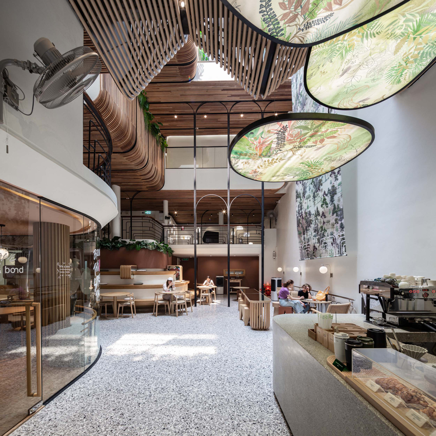 handcrafted wooden facade sweeps across VMA design studio’s hostel in bangkok