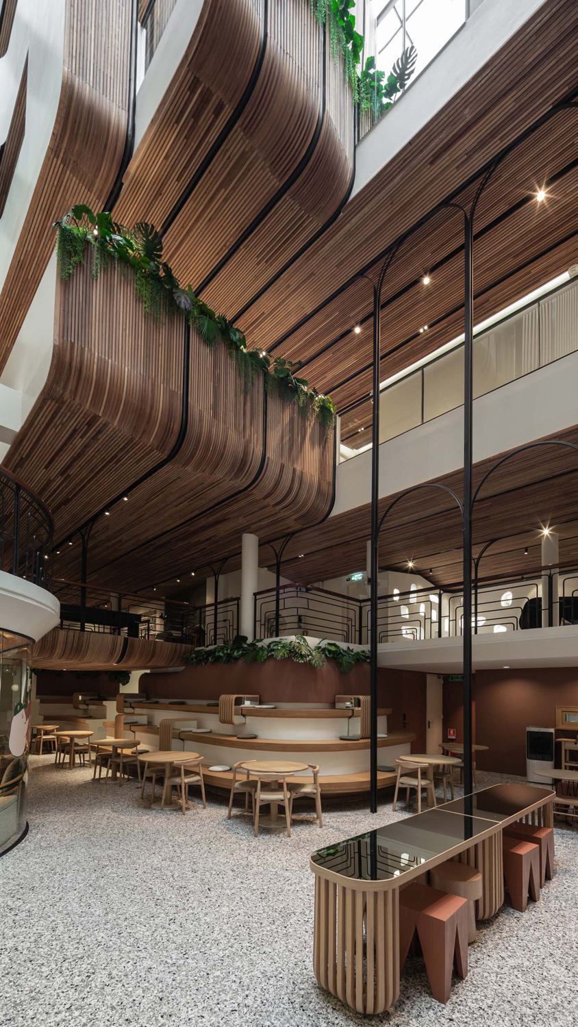 handcrafted wooden facade sweeps across VMA design studio’s hostel in bangkok