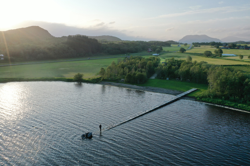 rever & drage extends stone and timber jetty from norwegian forest across the bay 