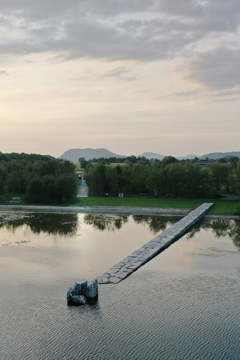 rever & drage extends stone and timber jetty from norwegian forest across the bay 
