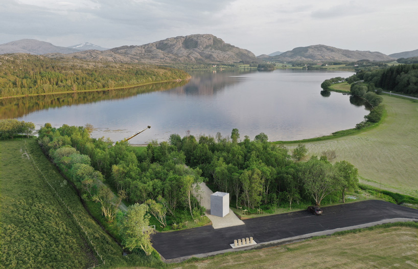 rever & drage extends stone and timber jetty from norwegian forest across the bay 