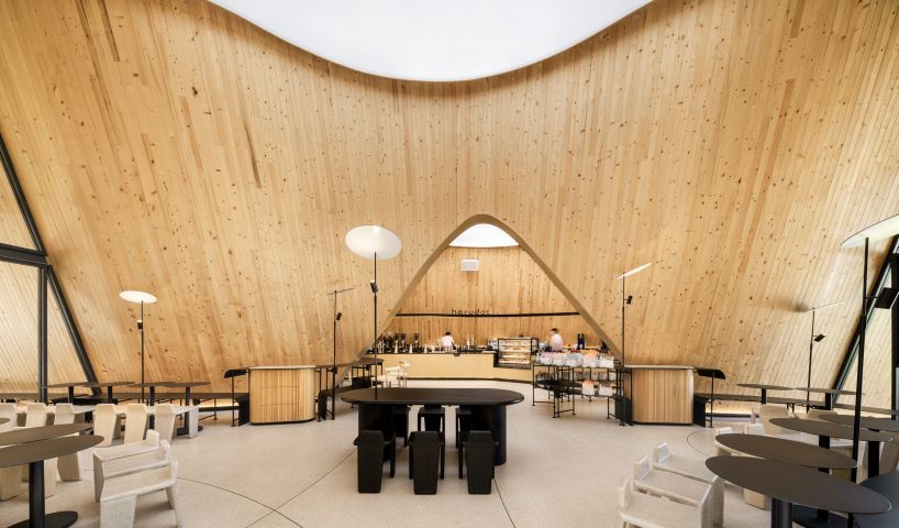 rounded openings pierce duo of sweeping gabled roofs at IDIN architects' bangkok café