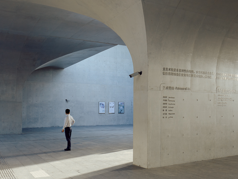 tianzhou yang captures concrete curves and coal hopper remnants at long museum, shanghai