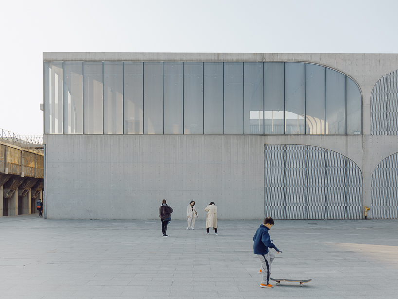 tianzhou yang captures concrete curves and coal hopper remnants at long museum, shanghai