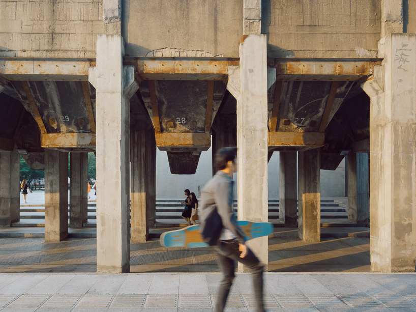 tianzhou yang captures concrete curves and coal hopper remnants at long museum, shanghai