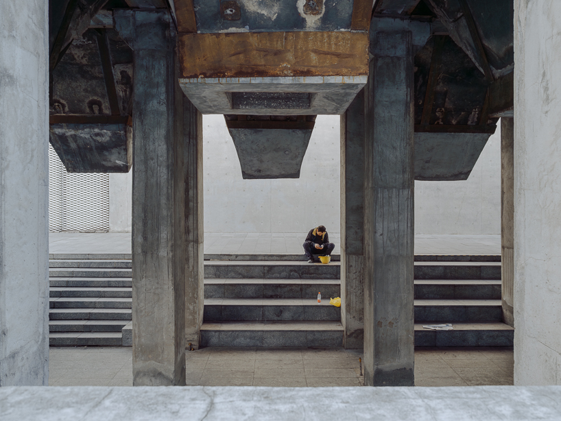 tianzhou yang captures concrete curves and coal hopper remnants at long museum, shanghai