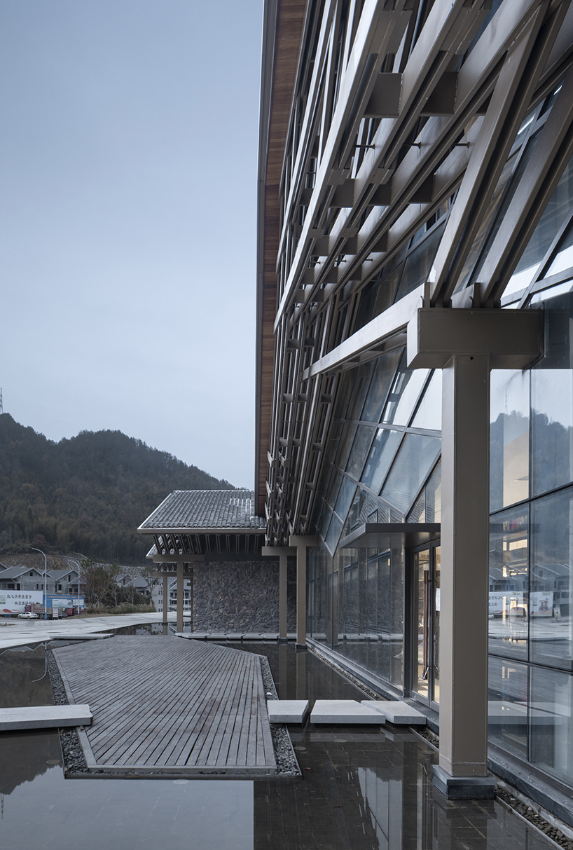 cascading folding roof of GLA design's community center in china echoes mountain contours