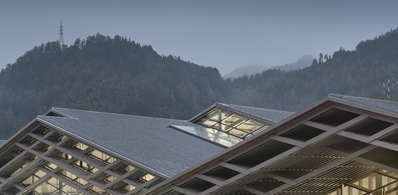 cascading folding roof of GLA design's community center in china echoes mountain contours