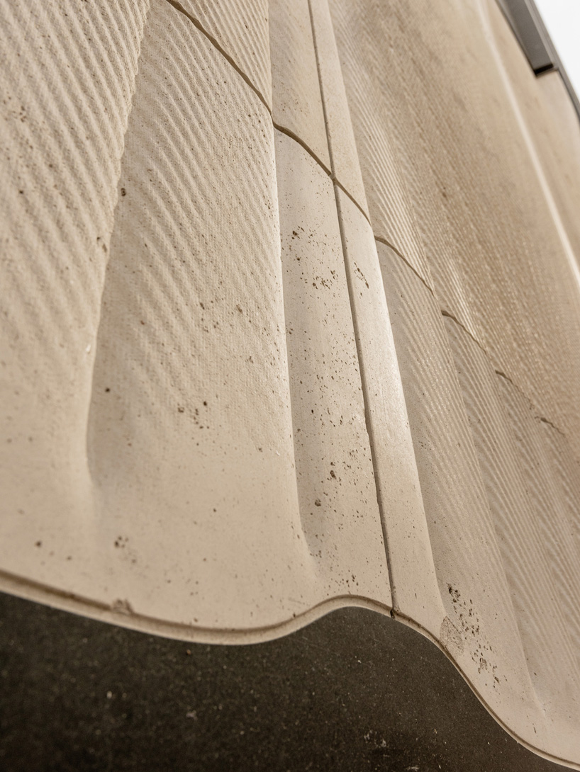 partisans sculpts parametric limestone facade with sinuous curves at toronto rolex boutique