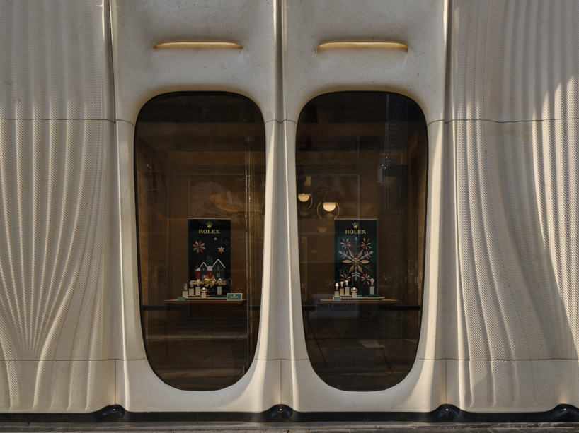 partisans sculpts parametric limestone facade with sinuous curves at toronto rolex boutique