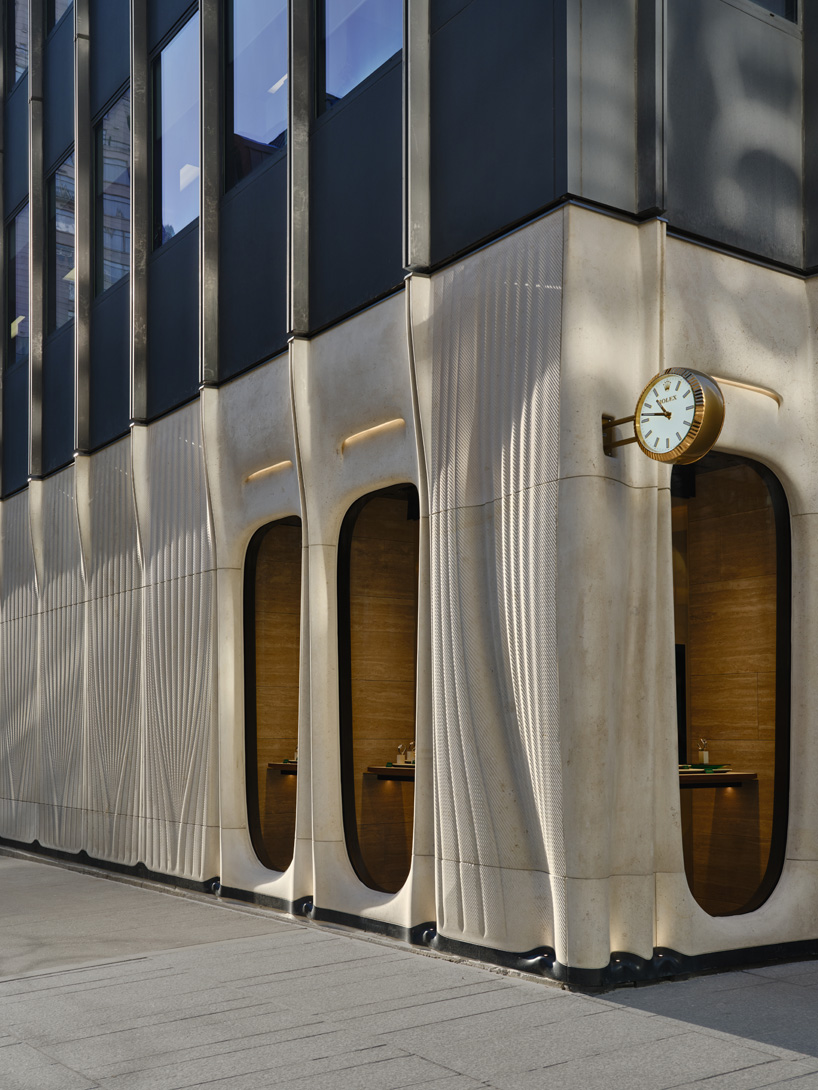 partisans sculpts parametric limestone facade with sinuous curves at toronto rolex boutique