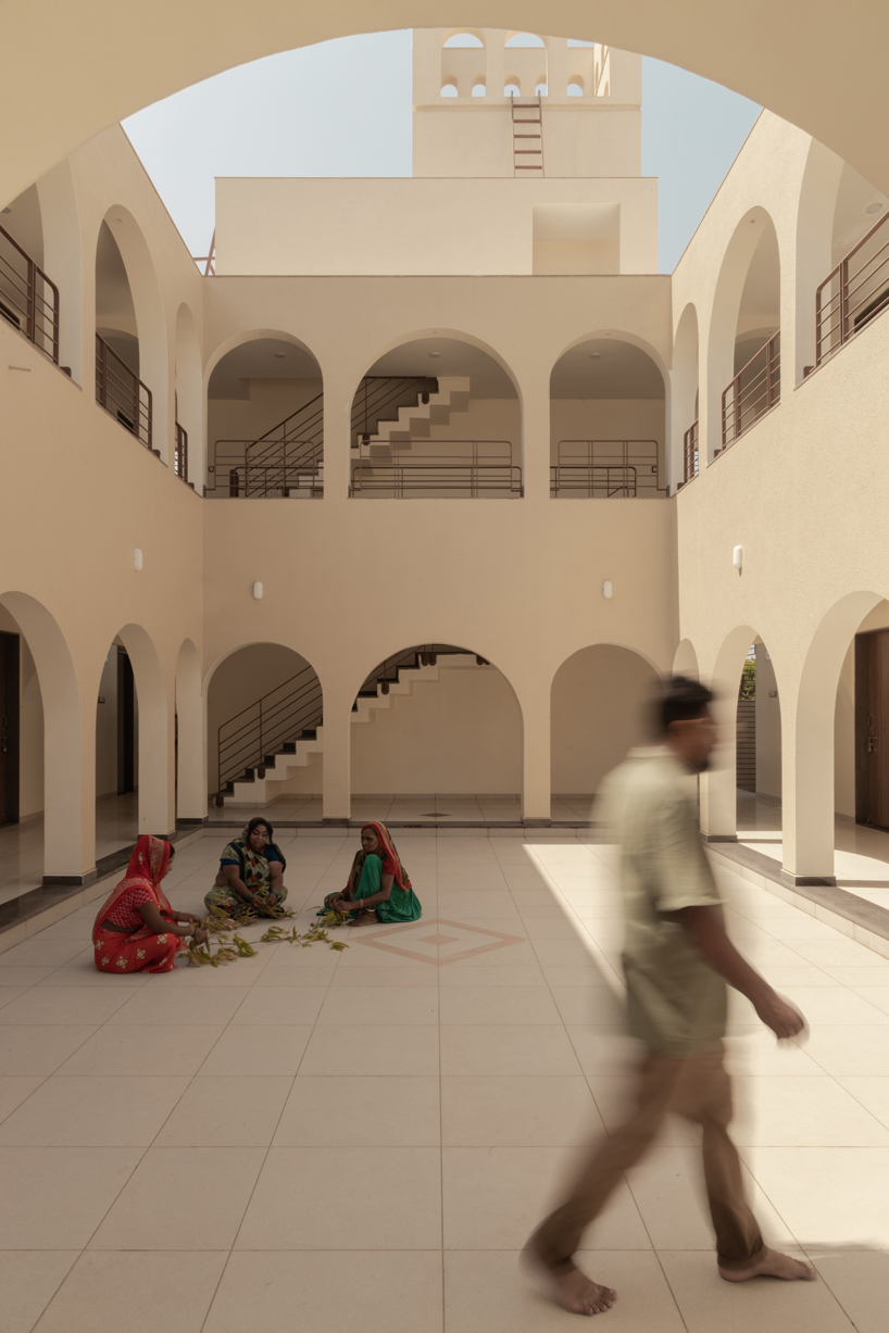 arches carve into ivory-colored walls of raasa architects' ashram in indian village