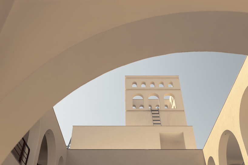 arches carve into ivory-colored walls of raasa architects' ashram in indian village