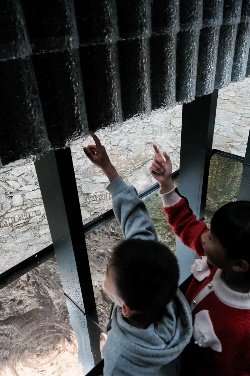 rain apparatus of aptdotapt's wooden pavilion in china inverts eaves, bringing water inside