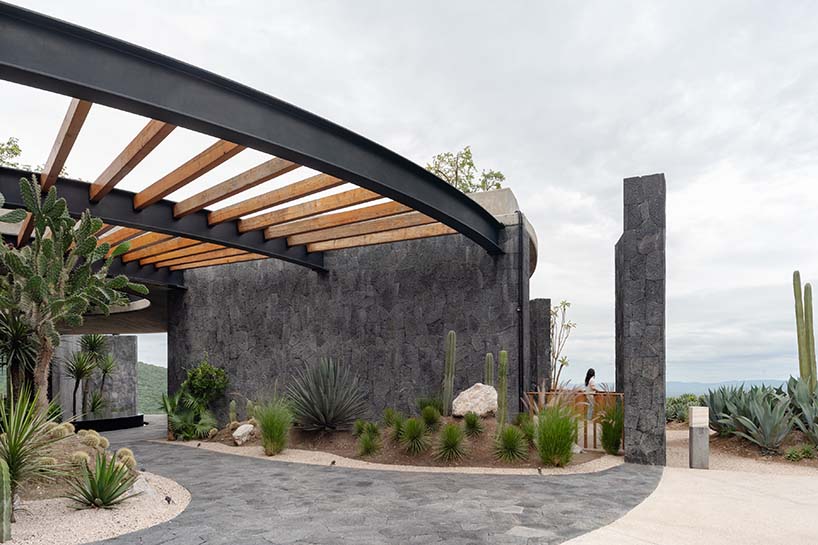 curved stone pavilion encloses circular reflecting pool for clubhouse in mexico