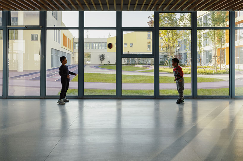 stacked color blocks and layered courtyards form a modular castle-like kindergarten in china - 9