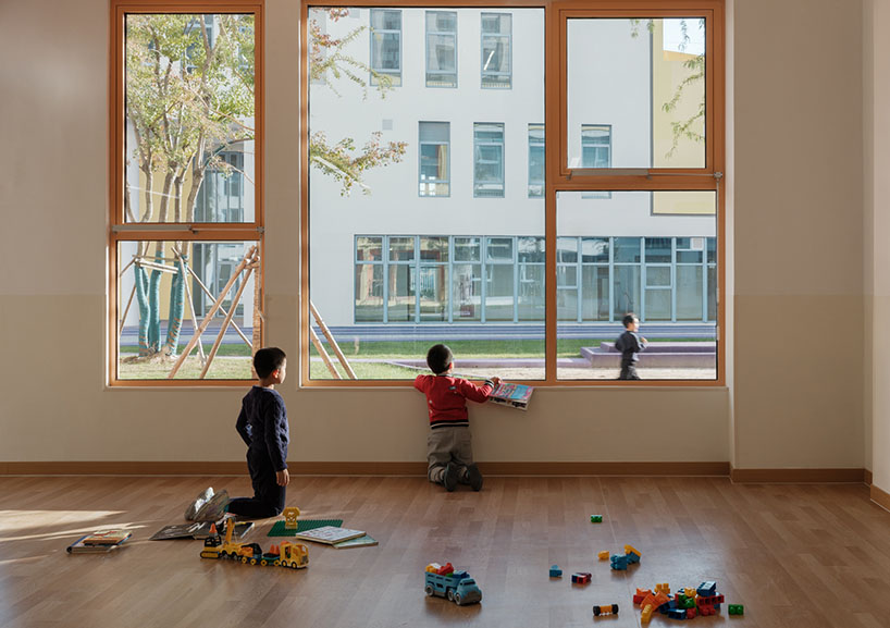 stacked color blocks and layered courtyards form a modular castle-like kindergarten in china - 10