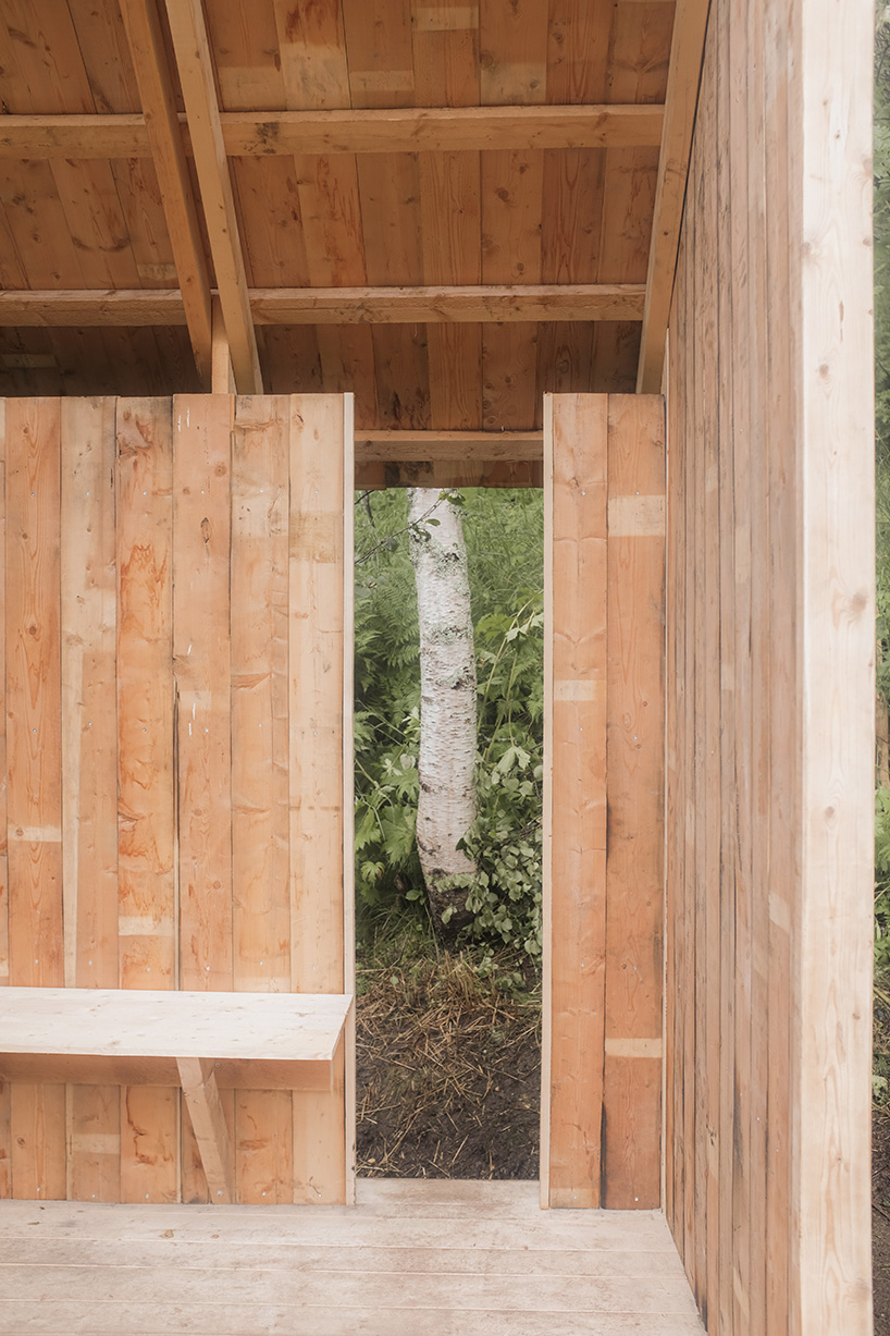 ma co builds glode fireplace shelter from reclaimed materials in northern norway 1