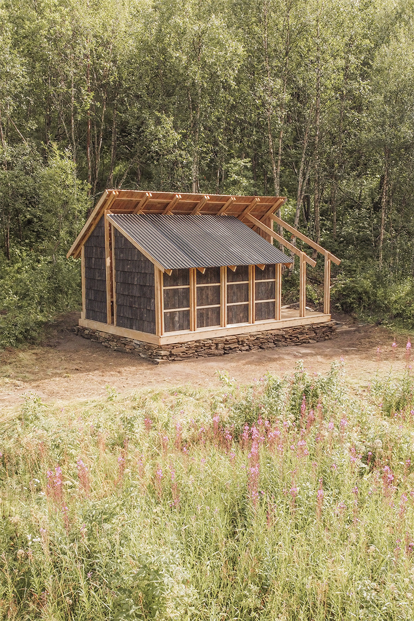 ma co builds glode fireplace shelter from reclaimed materials in northern norway 2