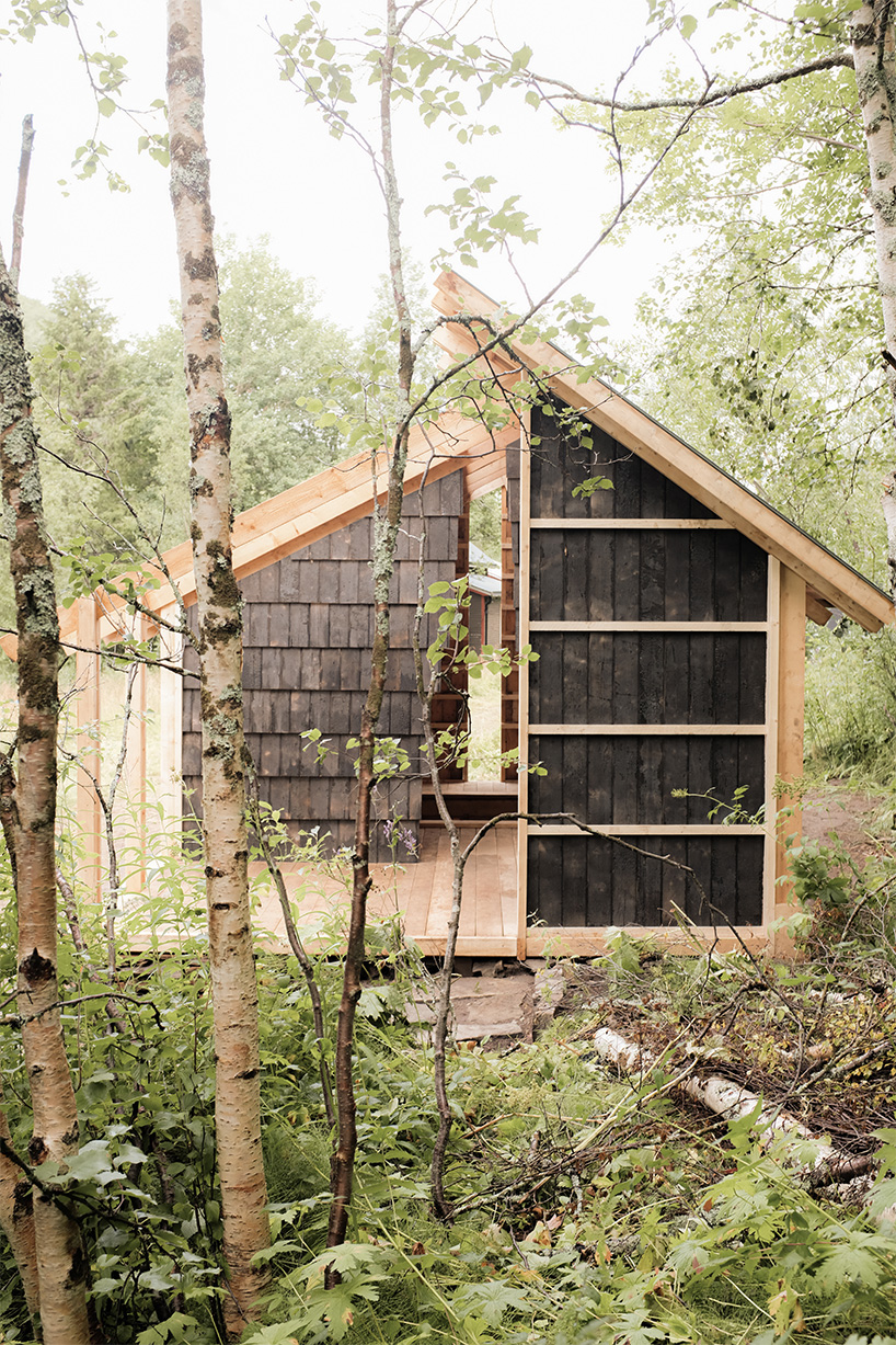 ma co builds glode fireplace shelter from reclaimed materials in northern norway 5