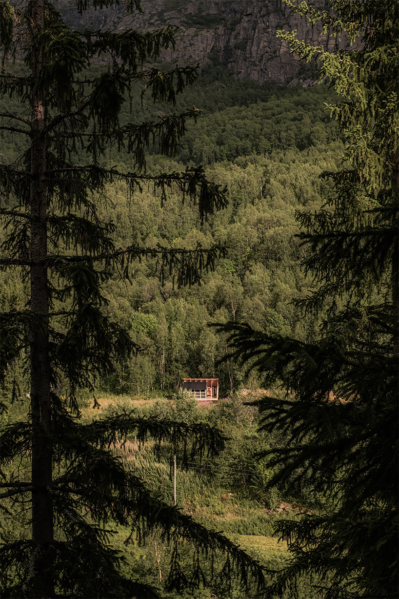 ma co builds glode fireplace shelter from reclaimed materials in northern norway 6