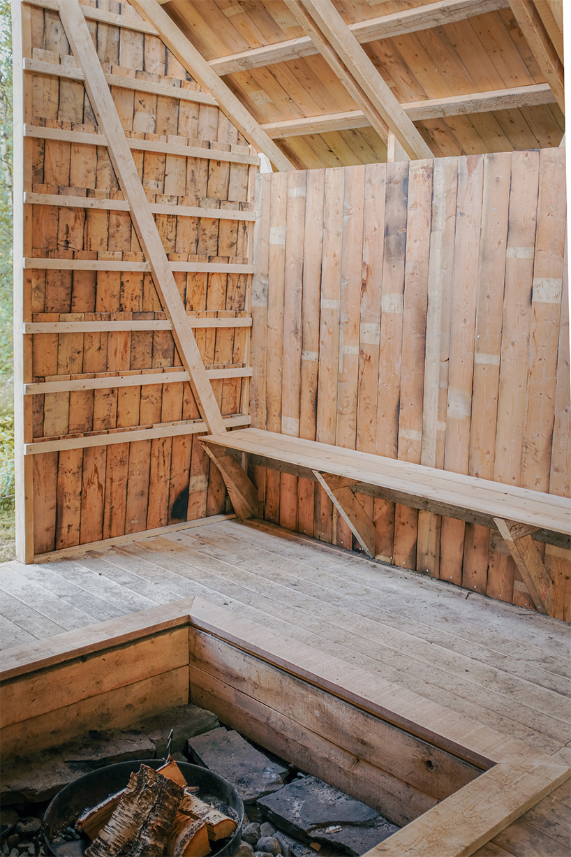 ma co builds glode fireplace shelter from reclaimed materials in northern norway 7