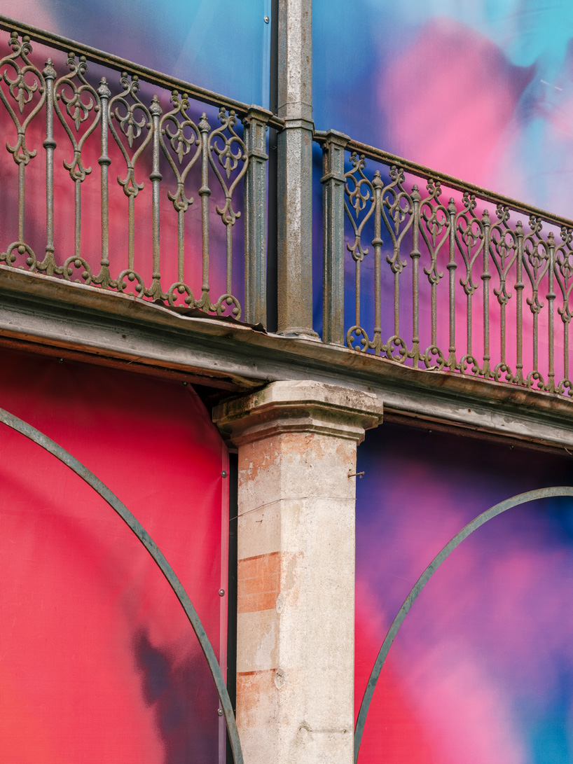 colorful printed textile installation reimagines historic laundry building facade in switzerland - 3