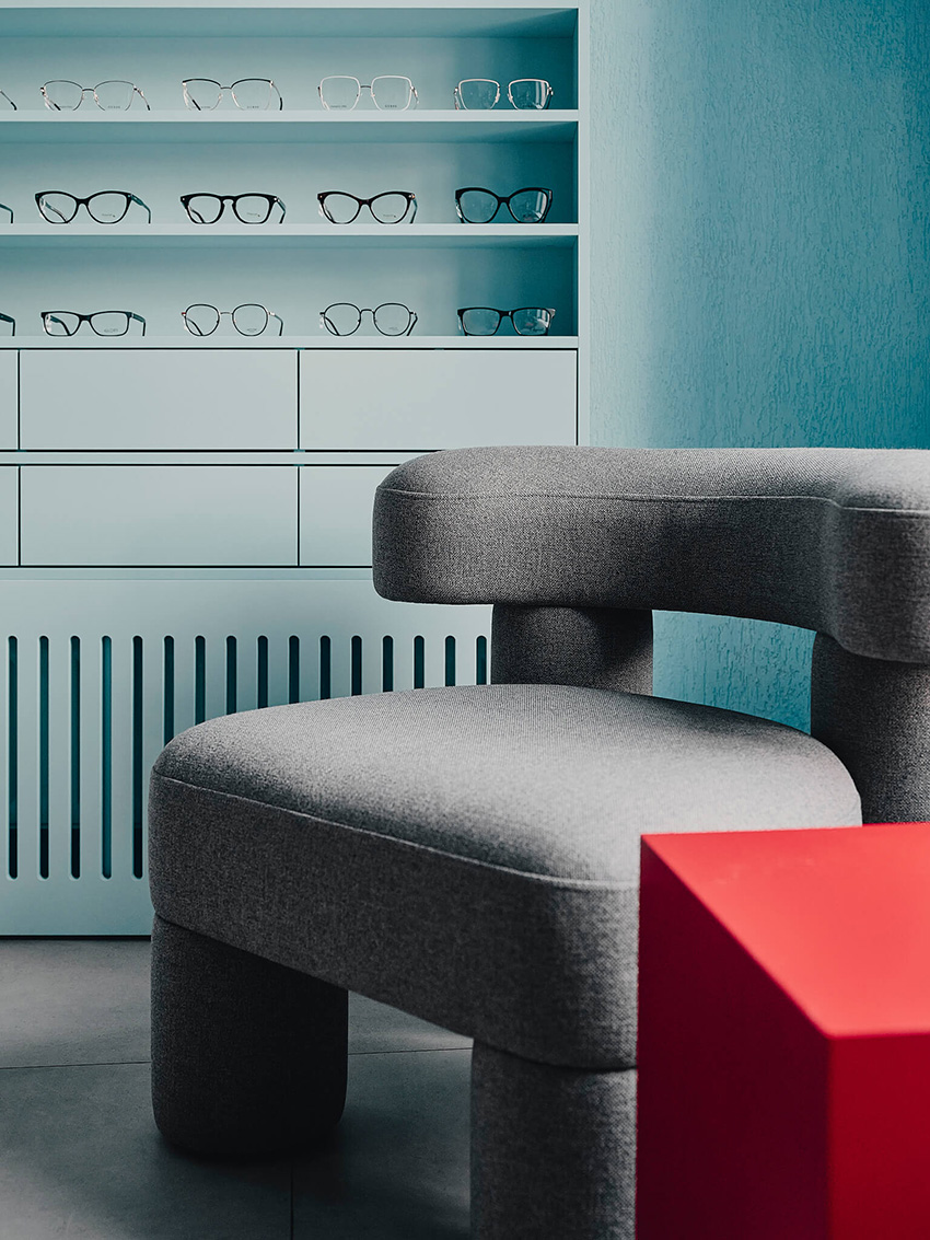 hubarch wraps an optics boutique in cold blue with single red interruption 10