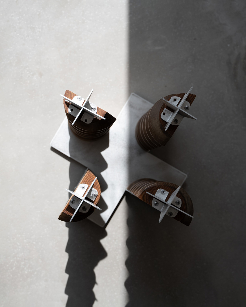 LE PRESSOIR stool showing its curved wooden legs and openwork metal structure