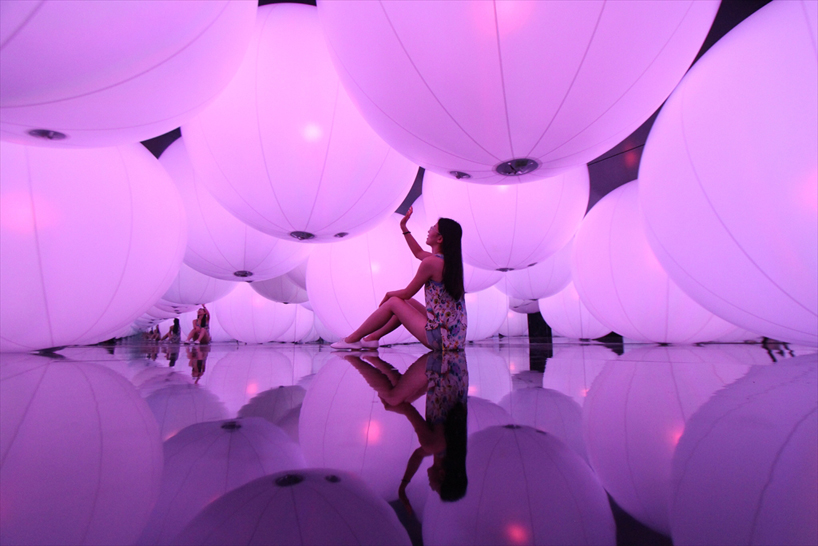 luminous colored spheres by team lab respond to human touch