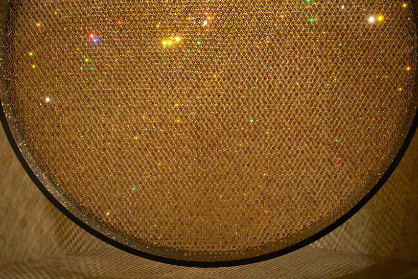 fredrikson stallard suspends 8,000 golden swarovski crystals in a luminous ring