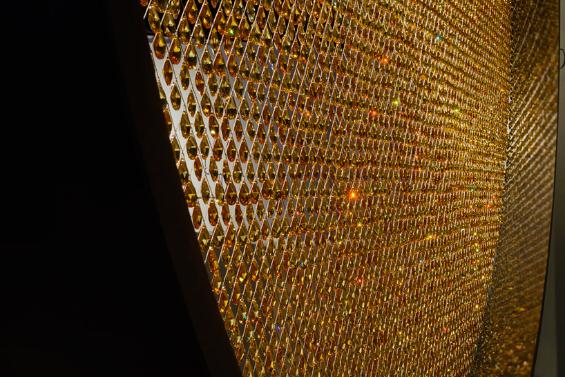 fredrikson stallard suspends 8,000 golden swarovski crystals in a luminous ring