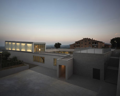 studio milani cantilevers the whale primary school above landscape