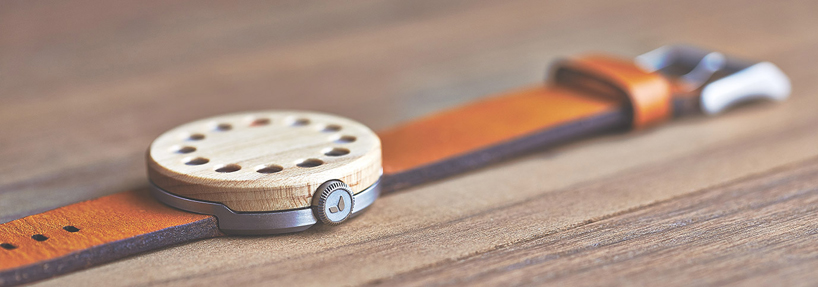 wooden analog watch by grovemade displays time with circular hands