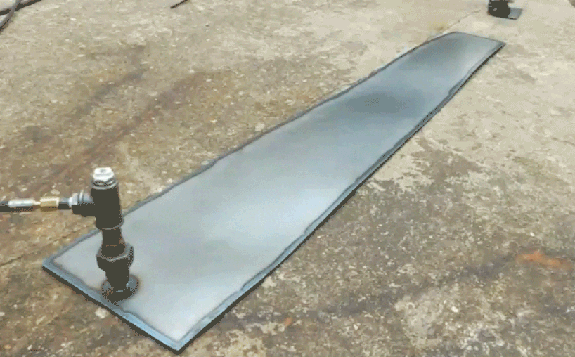 colin furze stands inside a fireworks display with self-built steel suit