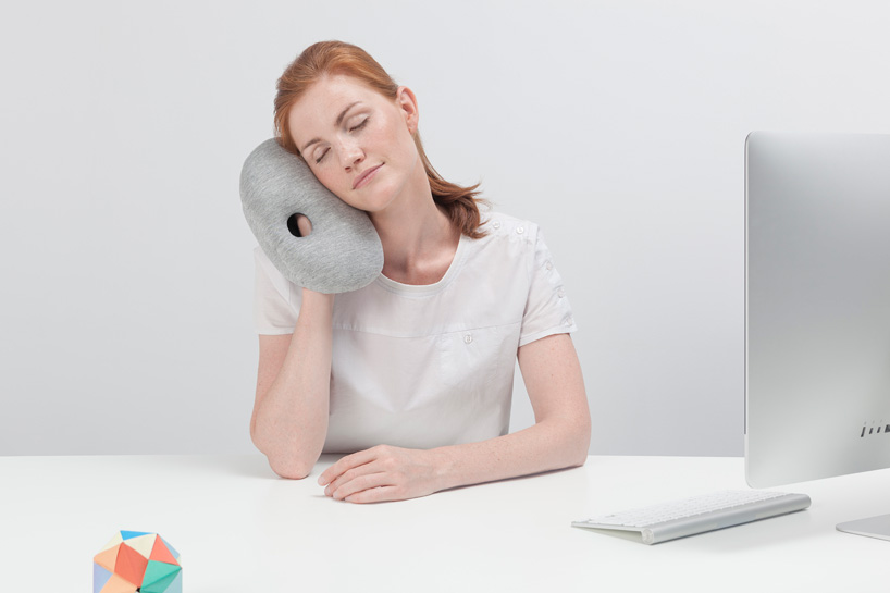 ostrich pillow mini attaches to hand, arm + elbow for easy napping