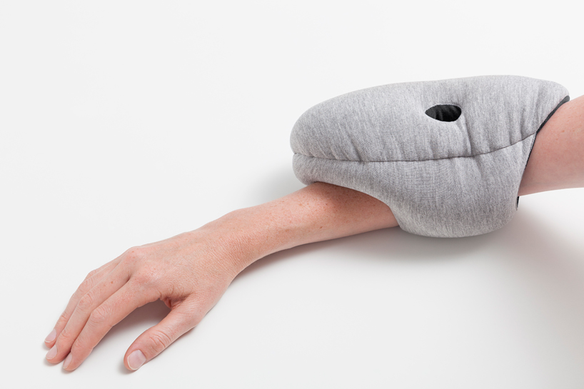 ostrich pillow mini attaches to hand, arm + elbow for easy napping