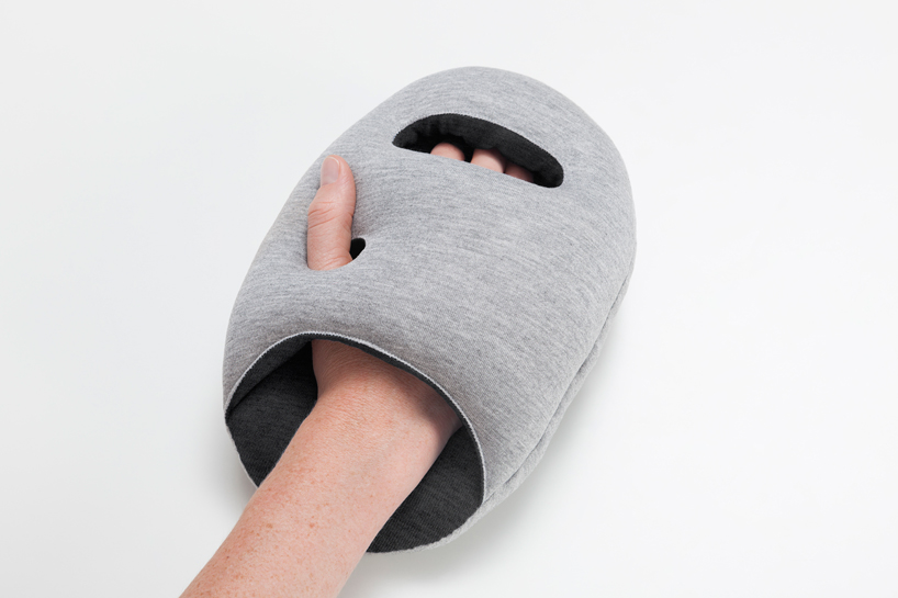 ostrich pillow mini attaches to hand, arm + elbow for easy napping