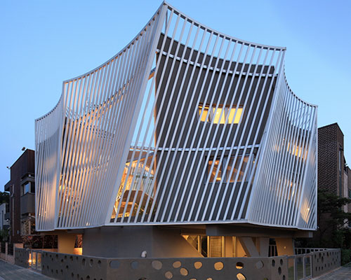 IROJE KHM architects construct kyeong dok jai within a louvered screen wall