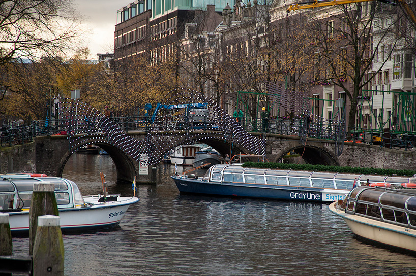 tjep. illuminates amsterdam's canals with undulating light bridge